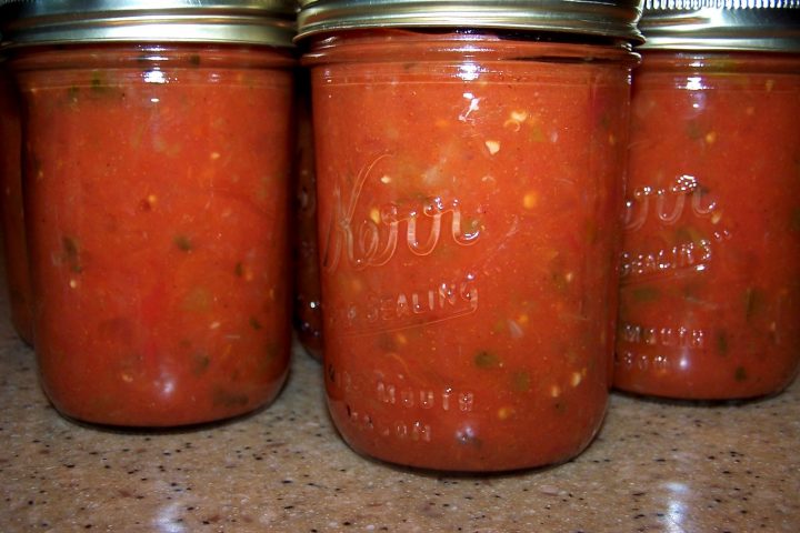 jars of Homemade Salsa for Canning on a kitchen counter