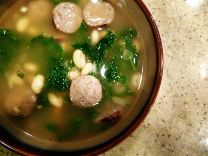 Overhead view of a bowl of Italian Sausage Kale White Bean Soup. 