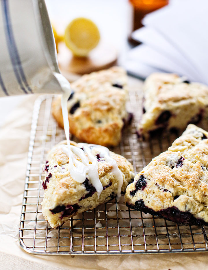 photo of lemon glaze pouring on blueberry lemon scones