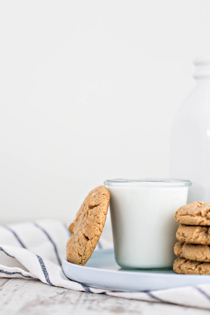 cookie leaning against glass of milk