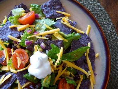 Overhead view of a veggie black bean taco salad on a plate.