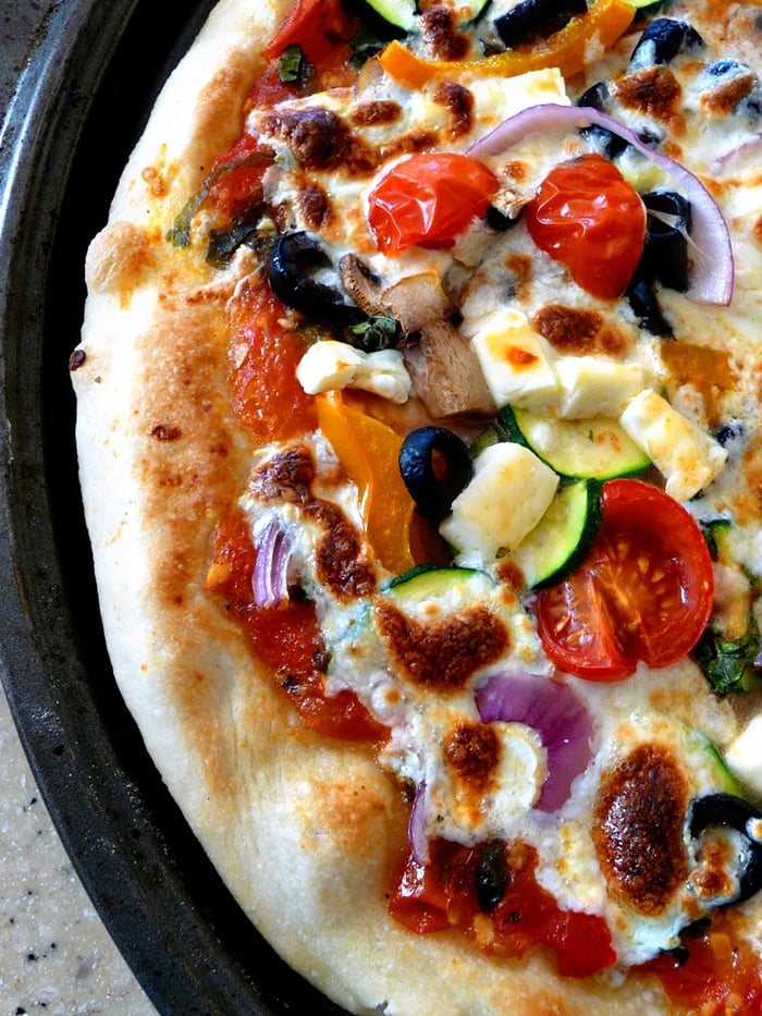 close up overhead photo of baked vegetarian pizza