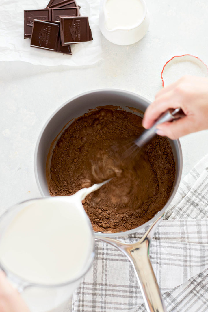 woman combining ingredients for the chocolate gelato base in a saucepan
