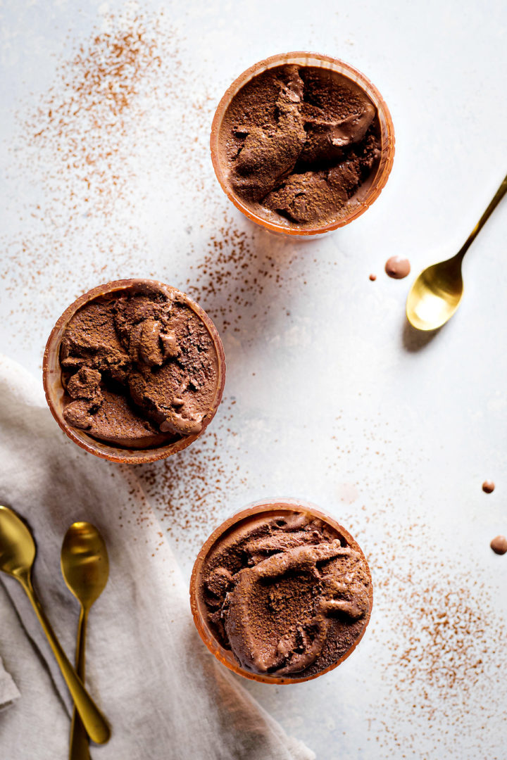 overhead photo of three bowls of chocolate gelato with gold spoons