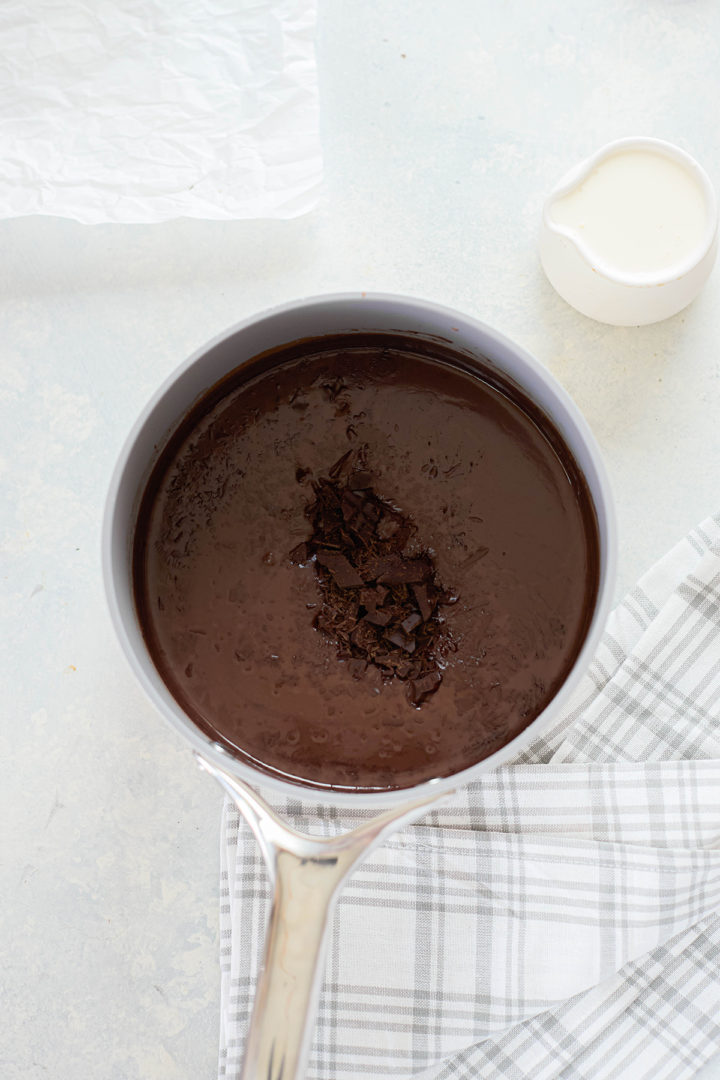 chocolate gelato base in a saucepan with chopped dark chocolate