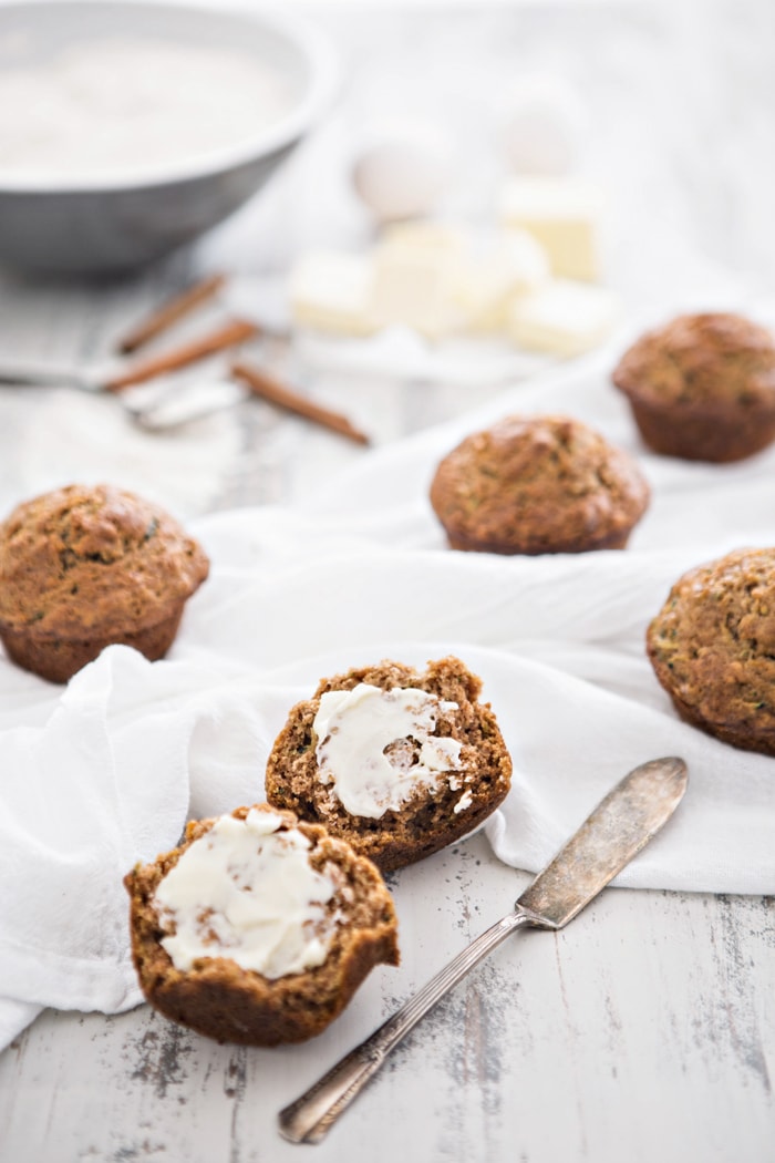 Zucchini Muffin cut in half with butter on it