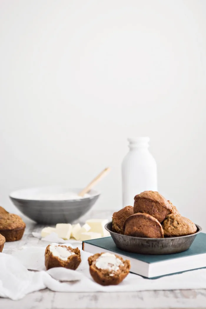 zucchini apple muffins on a table with ingredients
