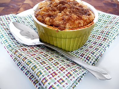 photo of a pumpkin cobbler in a ramekin with a spoon and napkin