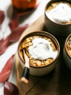 photo of homemade pumpkin cobbler in ramekins with whipped cream