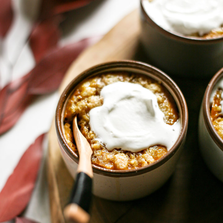 photo of homemade pumpkin cobbler in ramekins with whipped cream