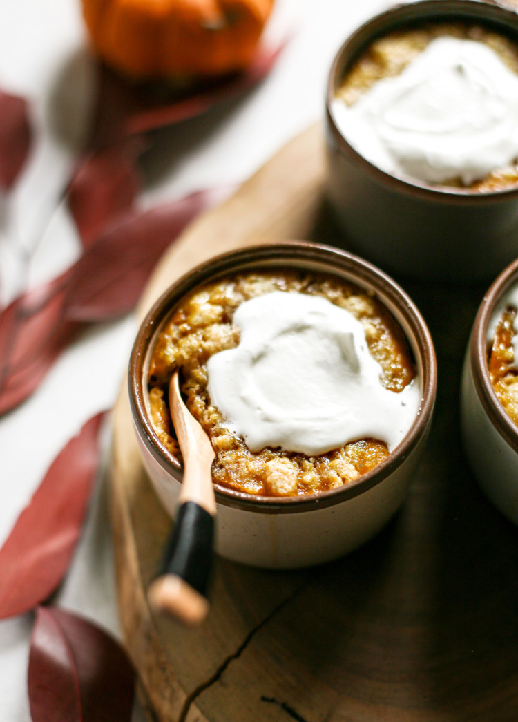 photo of homemade pumpkin cobbler in ramekins with whipped cream