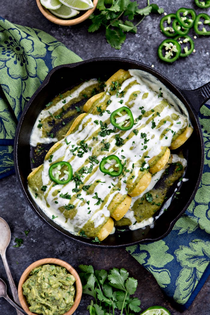 sour cream chicken enchiladas in cast iron skillet