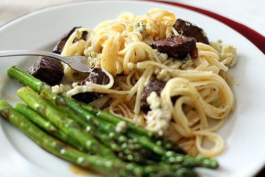 gorgonzola cream sauce pasta with asparagus on a white plate