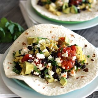 Black Bean Breakfast Burritos on plates on a table