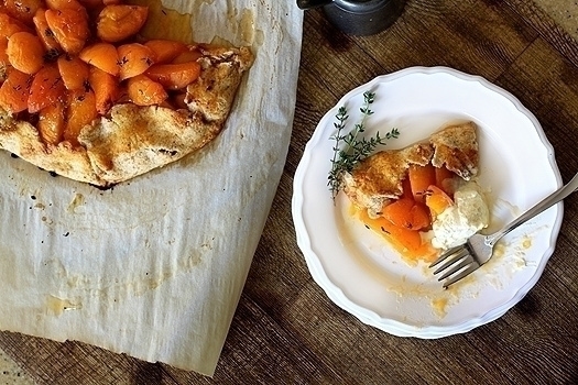 overhead photo of a baked apricot galette recipe next to a white plate with a slice of apricot galette on it