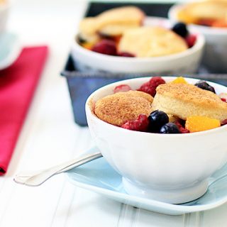 raspberry, blueberry, and peach cobbler with biscuit crust