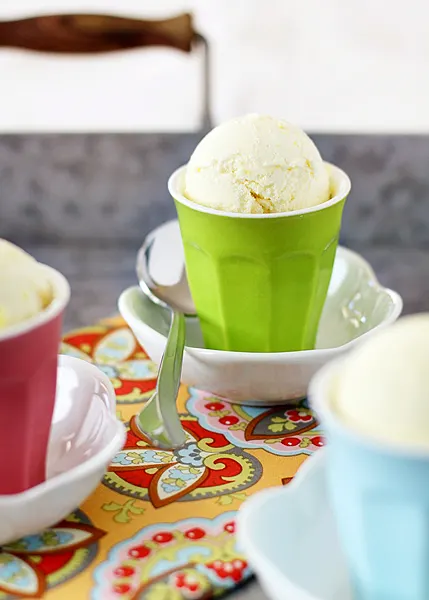 lemon ice cream in green cup with spoon