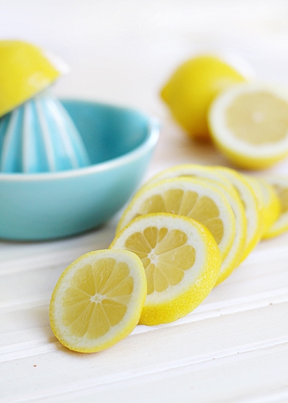 sliced lemons and a lemon squeezer for juicing to make spicy lemonade