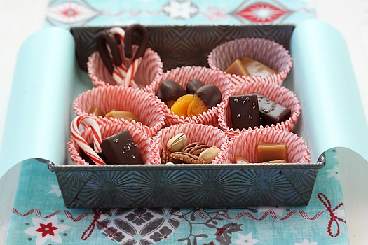 A box of homemade Christmas candies, including chocolate covered fleur de sel caramels. 