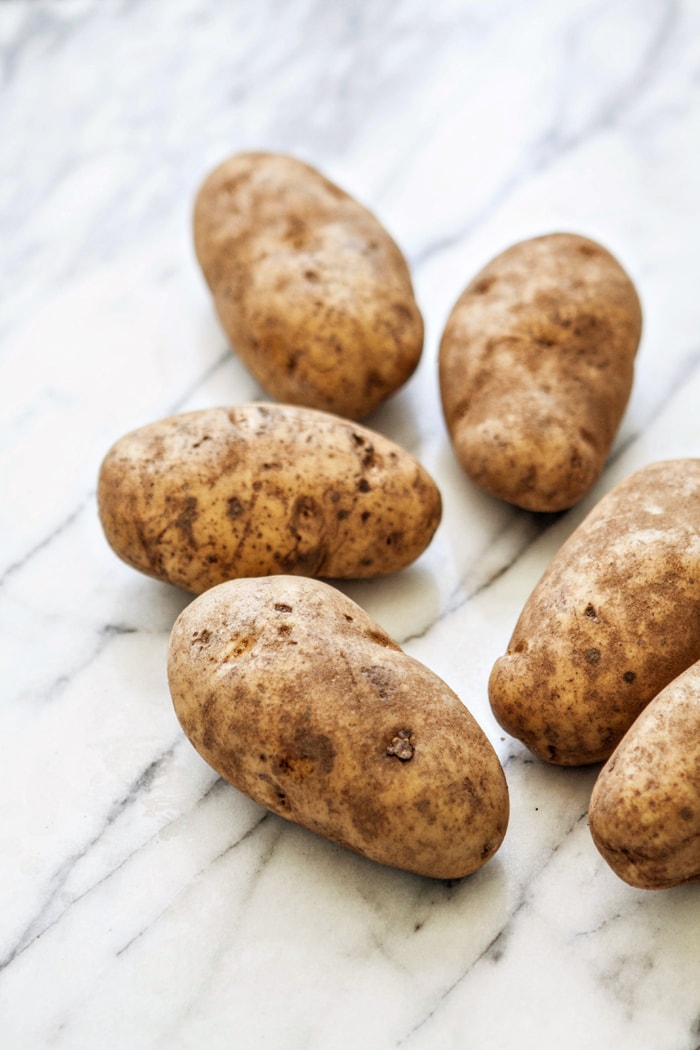 russet baked potatoes on a marble counter