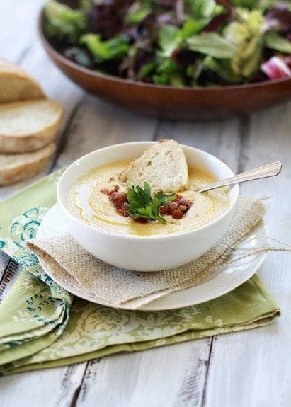 A bowl of roasted cauliflower soup topped with bacon