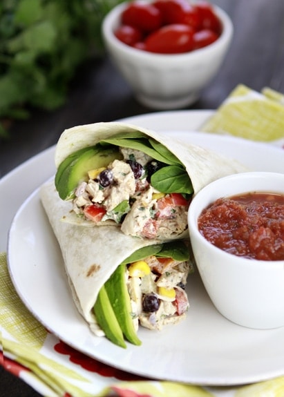 photo of a recipe for southwest chicken salad wrap cut in half on a white plate