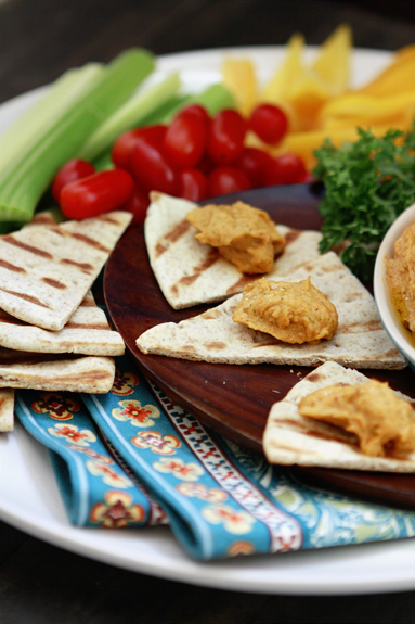 Photo of red pepper hummus on grilled pita bread