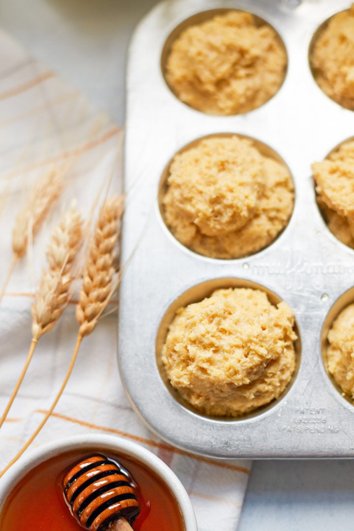 honey cornbread recipe in a muffin tin before baking