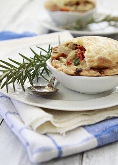 An Individual Chicken Pot Pie in a white dish. 