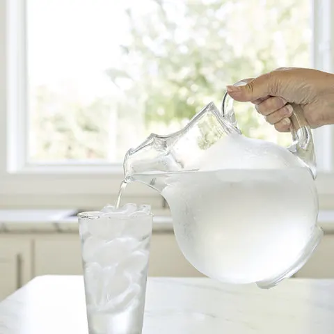 pitcher of water pouring into a glass