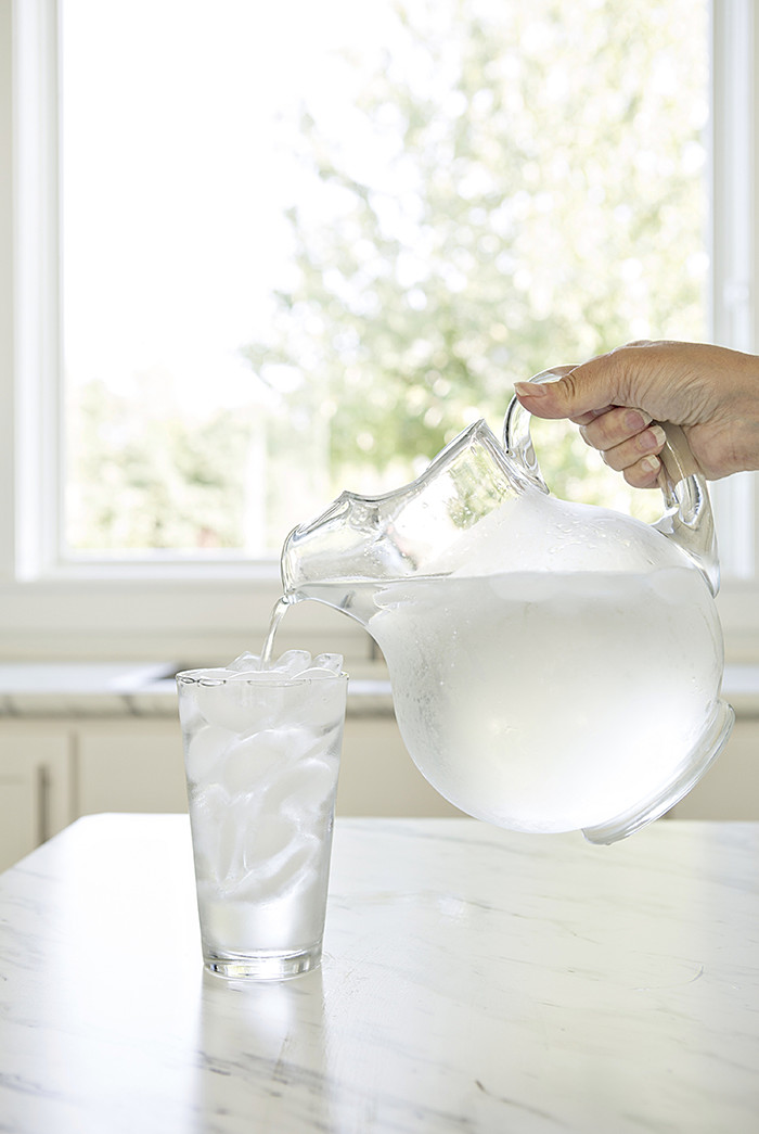 pitcher of water pouring into a glass