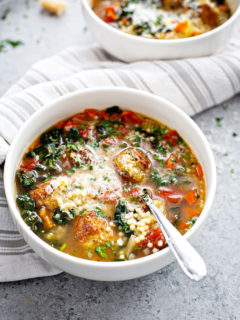white bowl with italian wedding soup and chicken meatballs