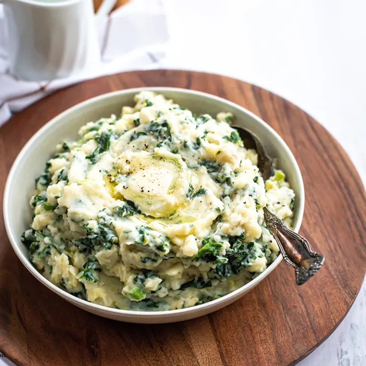 white bowl of irish mashed potatoes on a table