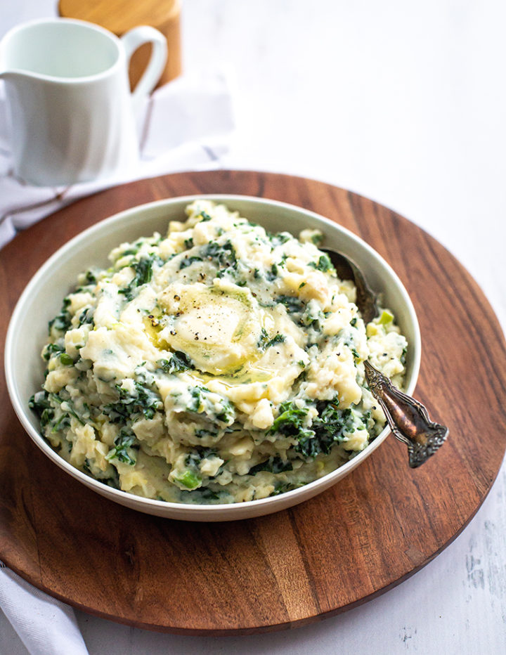 white bowl of irish mashed potatoes on a table