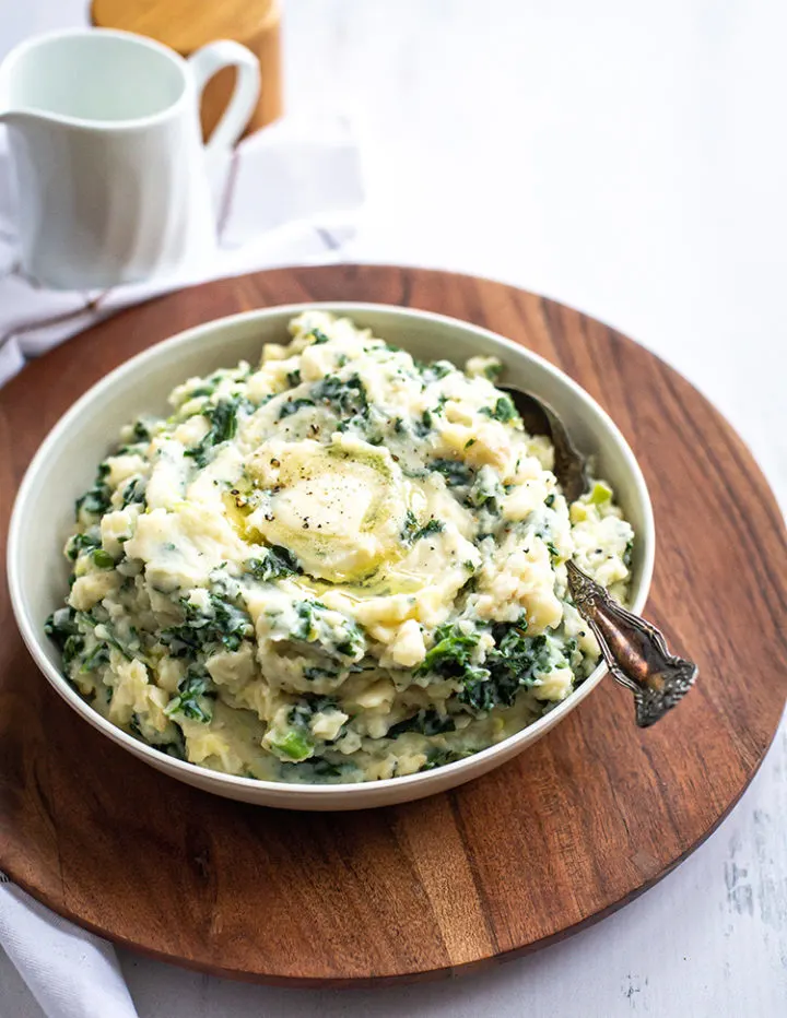 white bowl of irish mashed potatoes on a table