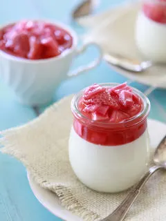 jars of vanilla bean panna cotta with strawberry rhubarb