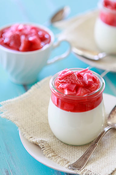 jars of vanilla bean panna cotta with strawberry rhubarb