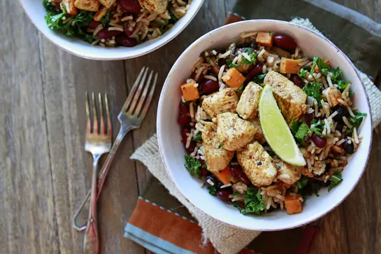 overhead photo of a mexican rice bowl with a slice of lime on top