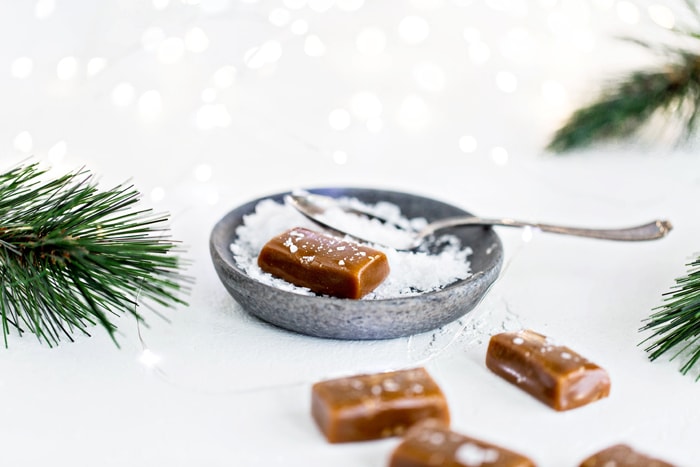 sea salt caramels next to pine branches