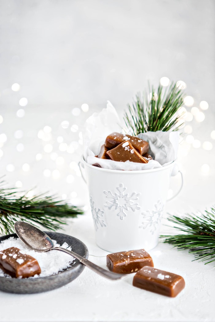 homemade caramels with sea salt next to pine branches