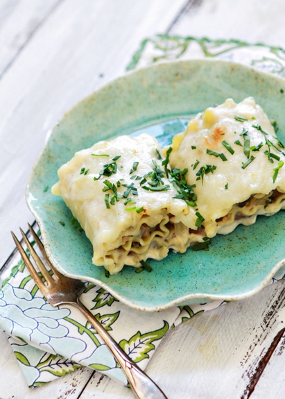 Spinach Artichoke and Chicken Lasagna rolls on a aqua colored plate