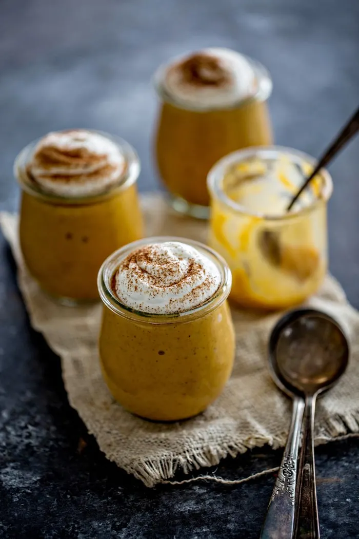 Four jars of pumpkin pudding, one jar has been eaten already.