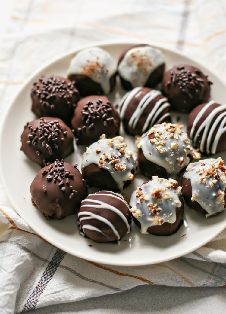 photo of chocolate covered pumpkin truffles on a white plate