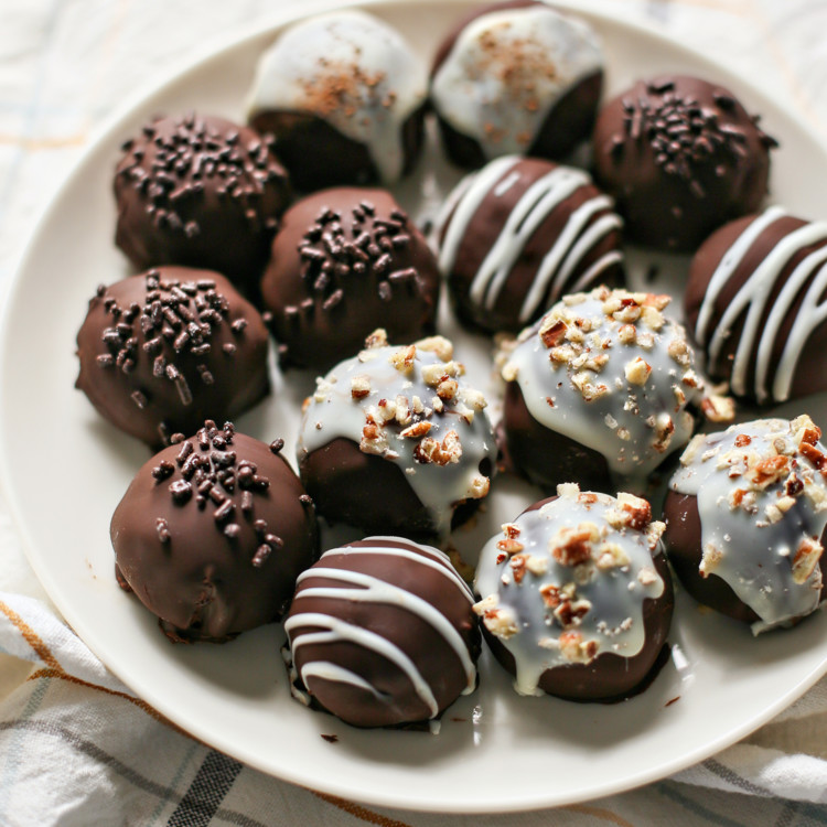 photo of chocolate covered pumpkin truffles on a white plate