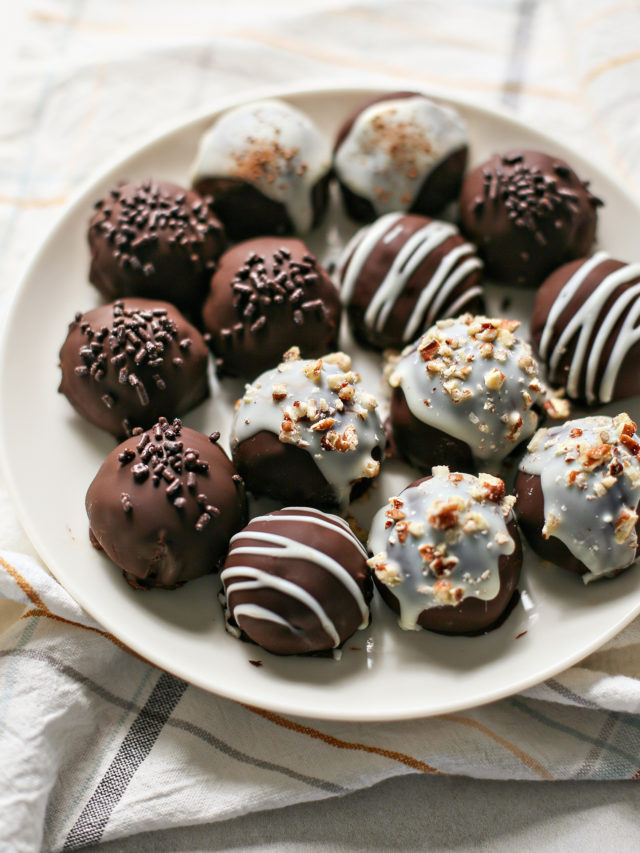 photo of chocolate covered pumpkin truffles on a white plate