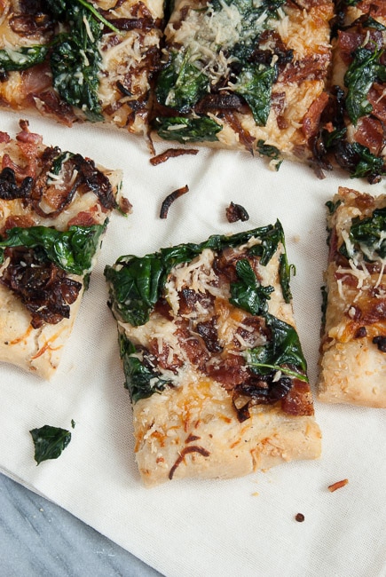 caramelized onion, spinach and bacon pizza