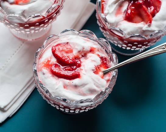 strawberries and cream in glass dessert dishes