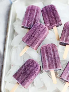 blueberry popsicles in a tray with ice cubes