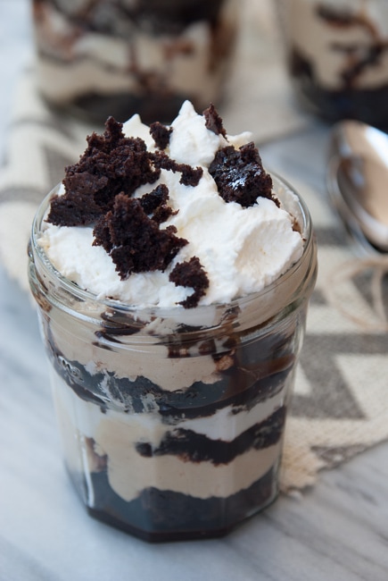 A chocolate brownie trifle in a glass jar. 