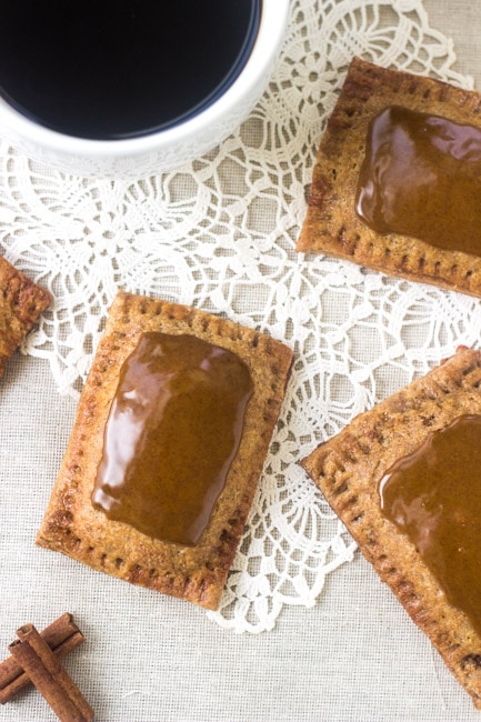 Overhead view of homemade brown sugar cinnamon pop tarts next to a mug of coffee 